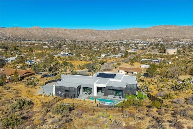 birds eye view of property with a mountain view