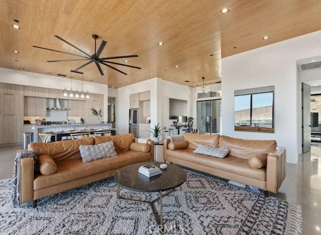 living room featuring wood ceiling and ceiling fan with notable chandelier