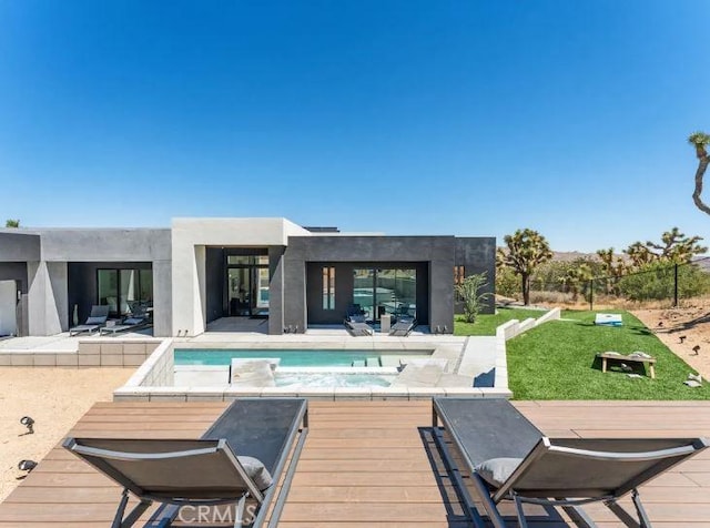 view of swimming pool with a wooden deck and a jacuzzi