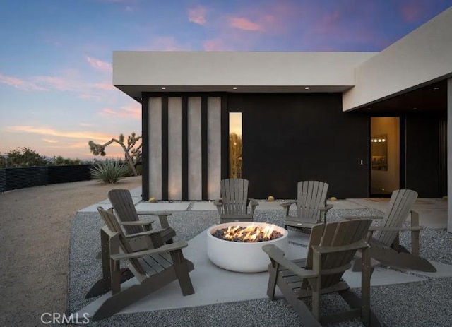 patio terrace at dusk with an outdoor fire pit