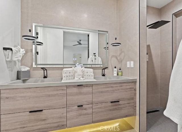 bathroom with vanity and a tile shower