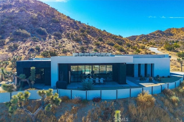 back of house featuring a mountain view