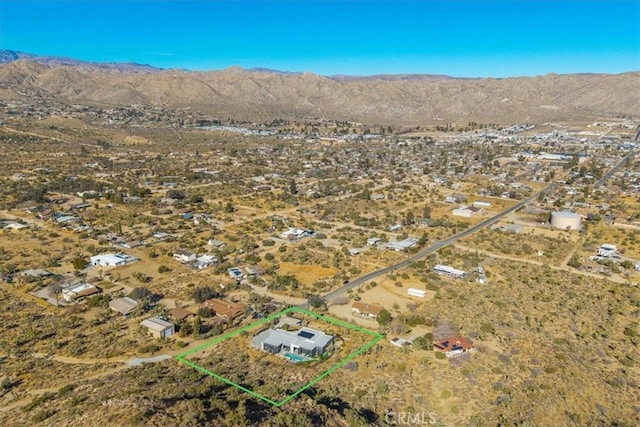 birds eye view of property with a mountain view