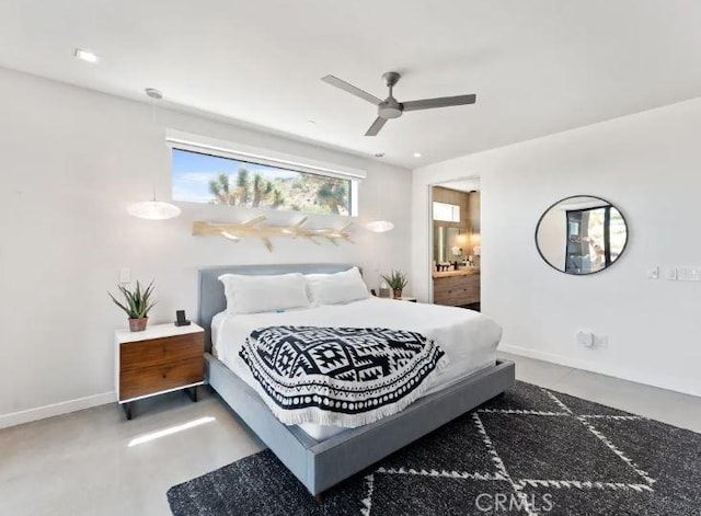 bedroom featuring ceiling fan, connected bathroom, and concrete flooring