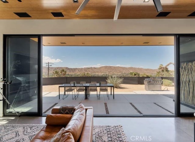 doorway to outside featuring a mountain view and wooden ceiling