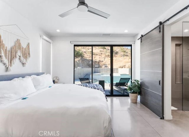 bedroom featuring a barn door, access to outside, and ceiling fan