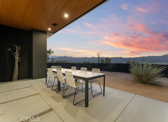 patio terrace at dusk with a mountain view