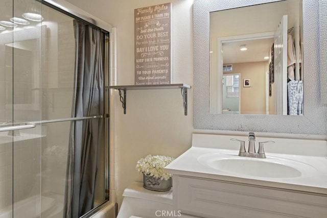 bathroom featuring walk in shower, vanity, and toilet