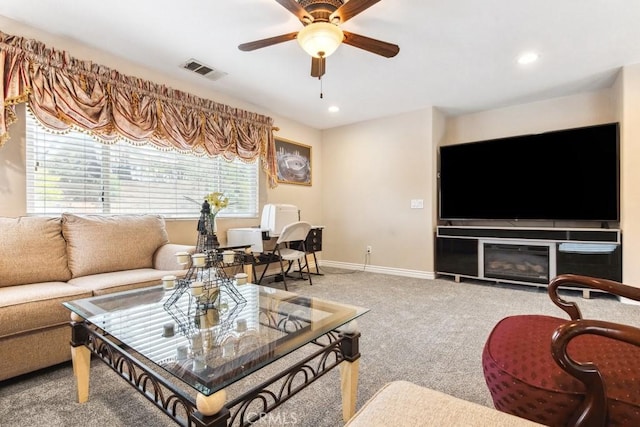 carpeted living room featuring ceiling fan