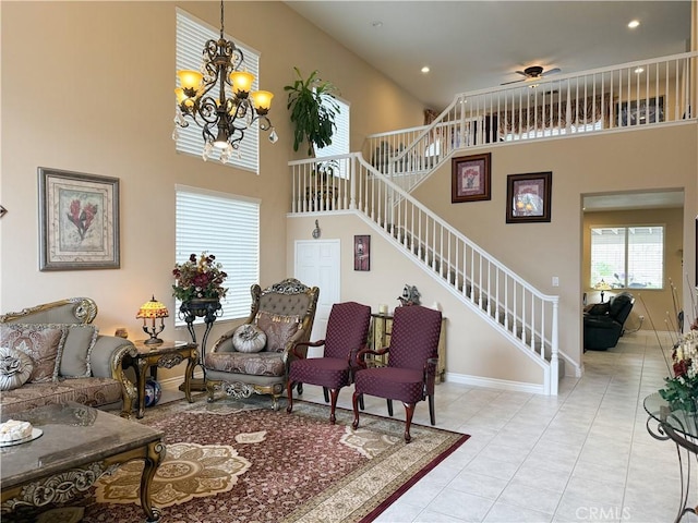 tiled living room featuring a high ceiling and a chandelier