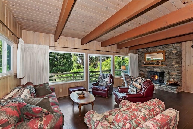 living room featuring dark hardwood / wood-style floors, wooden walls, and beam ceiling