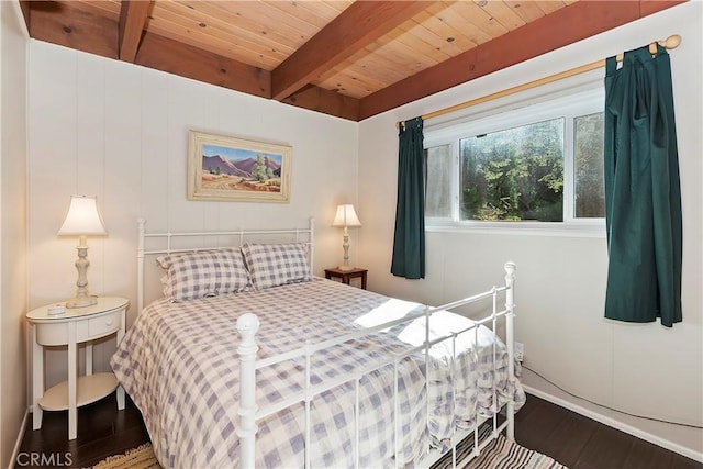 bedroom with beamed ceiling, dark hardwood / wood-style floors, and wooden ceiling