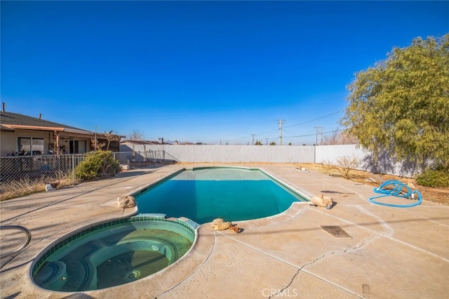 view of swimming pool with an in ground hot tub and a patio area