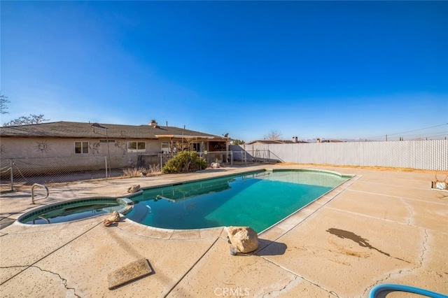 view of swimming pool featuring an in ground hot tub