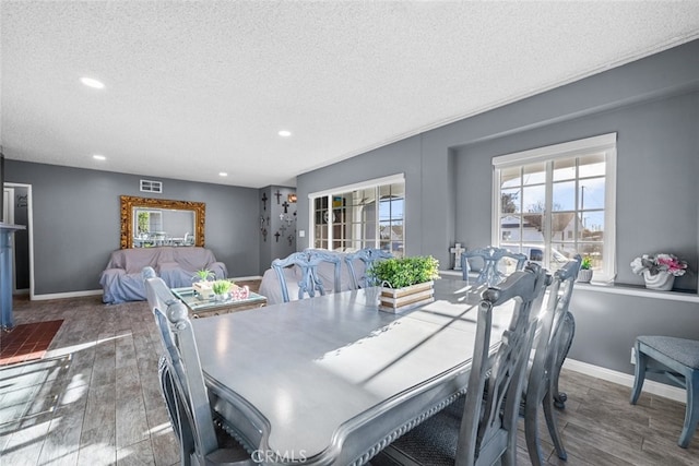 dining space featuring a textured ceiling