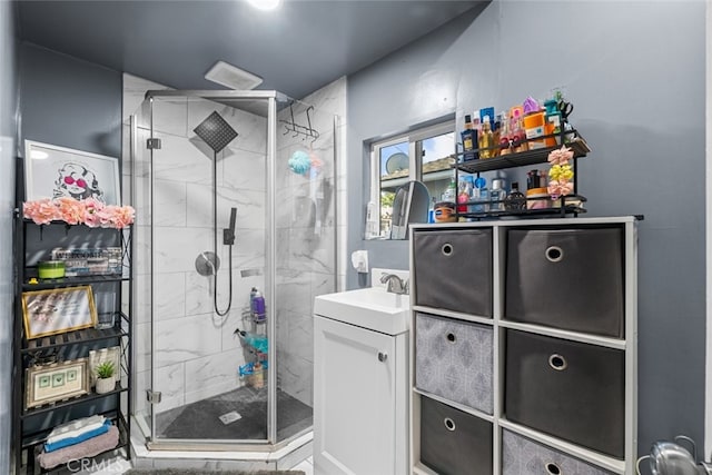 bathroom featuring walk in shower and vanity