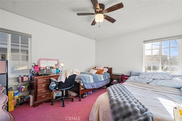 carpeted bedroom with a textured ceiling and ceiling fan