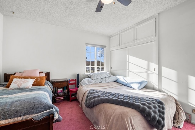 bedroom with ceiling fan, carpet floors, and a textured ceiling