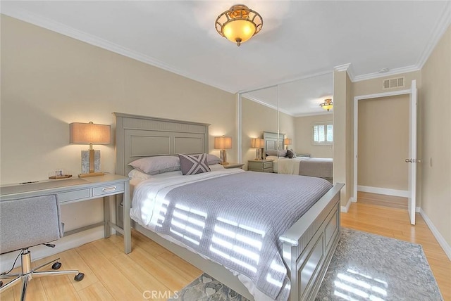 bedroom featuring crown molding and light hardwood / wood-style flooring