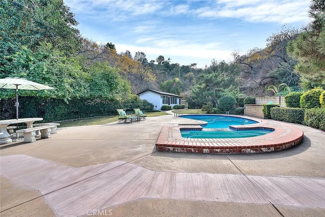 view of swimming pool with an in ground hot tub and a patio area