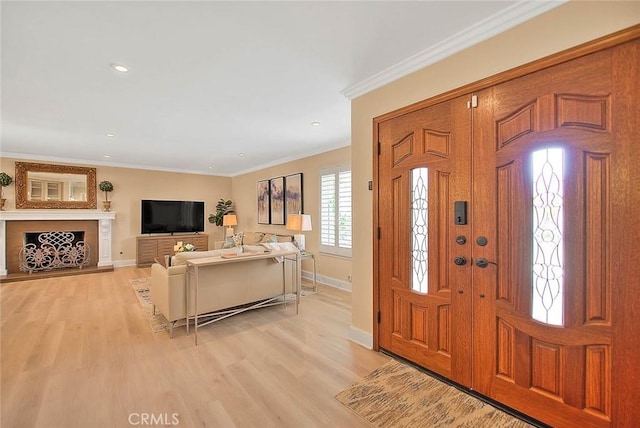 foyer featuring crown molding and light hardwood / wood-style flooring