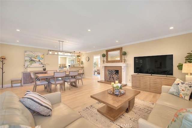 living room featuring ornamental molding and light hardwood / wood-style floors