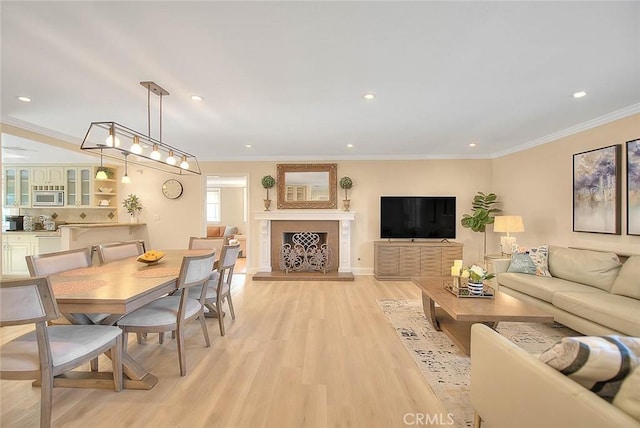 living room with crown molding and light hardwood / wood-style flooring