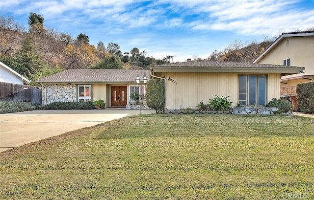 ranch-style home with a front lawn