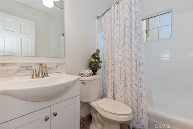 full bathroom with vanity, shower / bath combo, and toilet