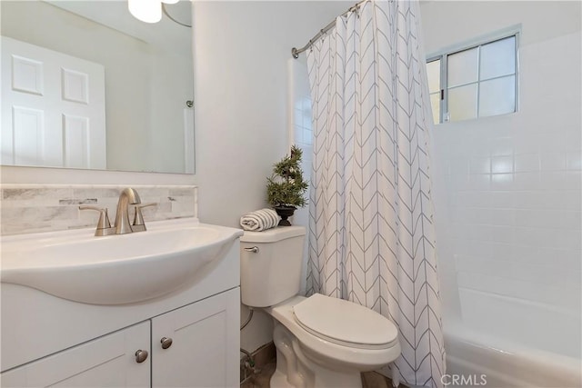 full bath featuring shower / bathtub combination with curtain, toilet, and vanity