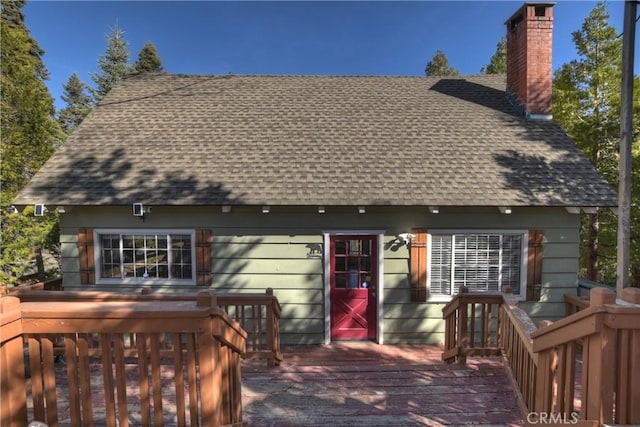 rear view of house with a wooden deck