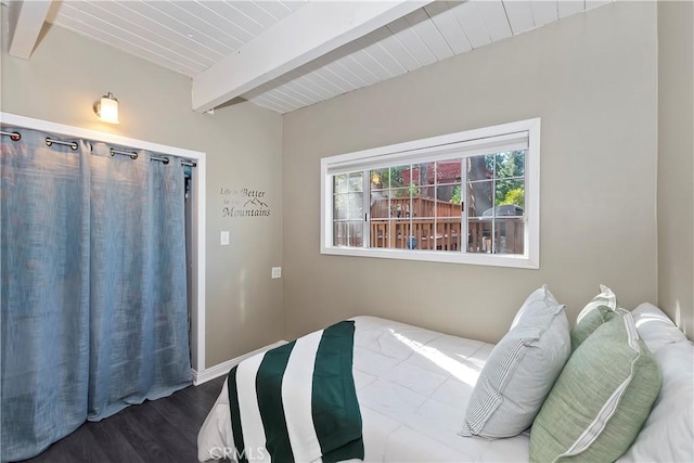 bedroom with beam ceiling, wooden ceiling, and wood finished floors