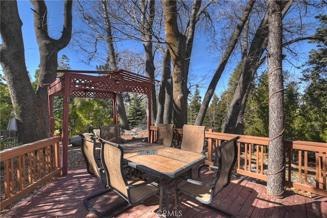 wooden deck featuring outdoor dining area and a pergola