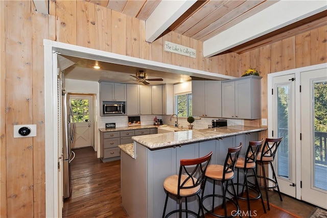 28621 Shenandoah Dr, Lake Arrowhead, CA 92352 - kitchen with stainless steel microwave, gray cabinets, backsplash, a peninsula, and beamed ceiling