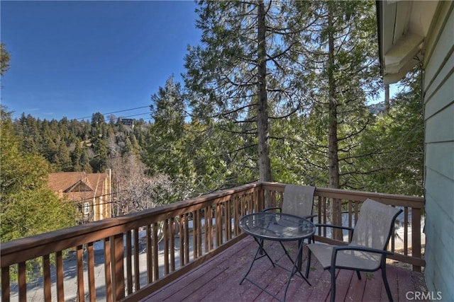 28621 Shenandoah Dr, Lake Arrowhead, CA 92352 - wooden deck featuring a view of trees