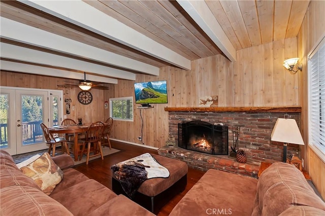 28621 Shenandoah Dr, Lake Arrowhead, CA 92352 - living room with wood finished floors, wood walls, a brick fireplace, beam ceiling, and french doors