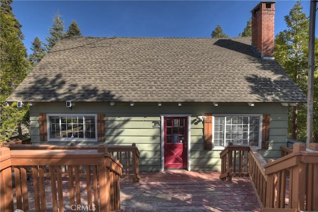 28621 Shenandoah Dr, Lake Arrowhead, CA 92352 - back of property featuring a shingled roof, a deck, and a chimney
