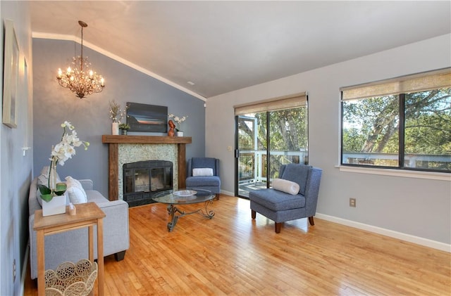 living room featuring lofted ceiling, a chandelier, and wood-type flooring