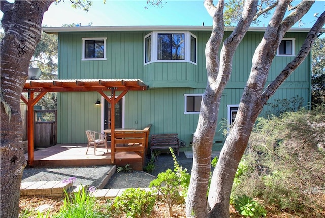 rear view of house featuring a wooden deck