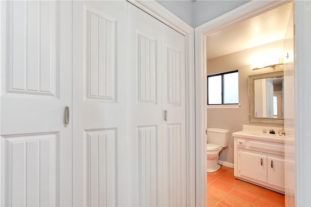 bathroom featuring tile patterned flooring, vanity, and toilet