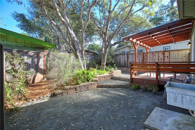 view of yard featuring a pergola, a patio area, and a deck