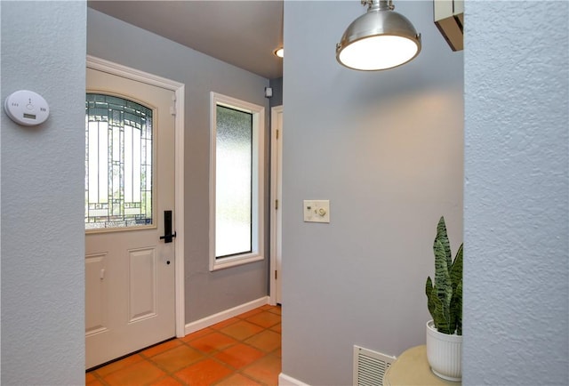 tiled foyer entrance with a healthy amount of sunlight