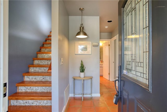 entryway with light tile patterned flooring