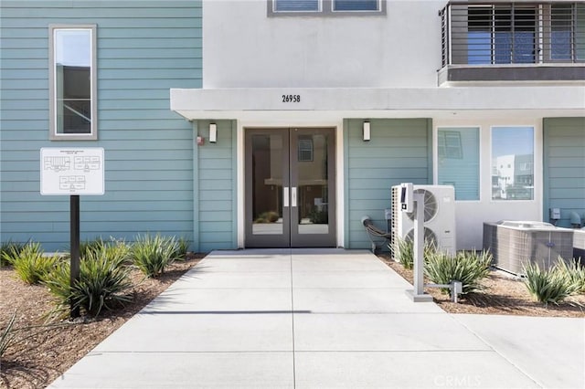 property entrance featuring central AC unit, ac unit, and french doors