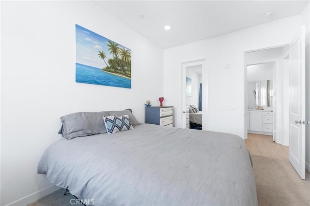 bedroom featuring recessed lighting, light carpet, and baseboards