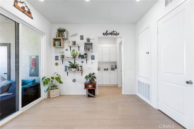 mudroom with light wood-style flooring, visible vents, and baseboards