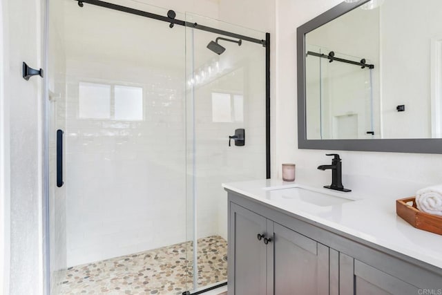 bathroom featuring vanity and an enclosed shower