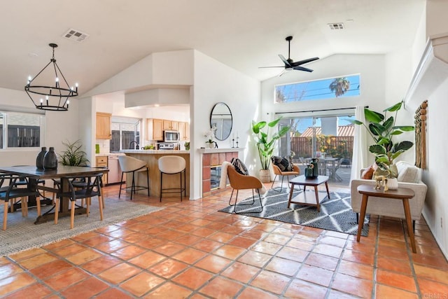 living room featuring high vaulted ceiling, sink, ceiling fan with notable chandelier, and light tile patterned floors