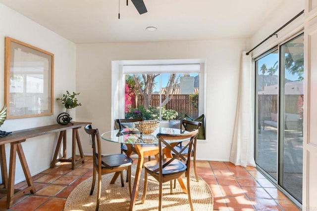 tiled dining area with a wealth of natural light and ceiling fan