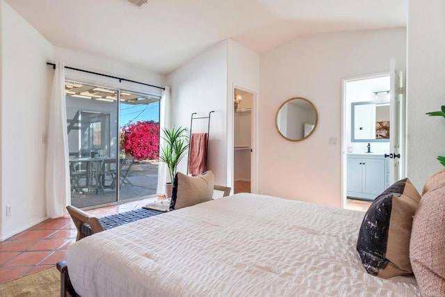 bedroom featuring lofted ceiling, a spacious closet, access to outside, light tile patterned floors, and a closet